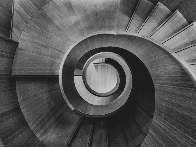 a black and white photo of a spiral staircase